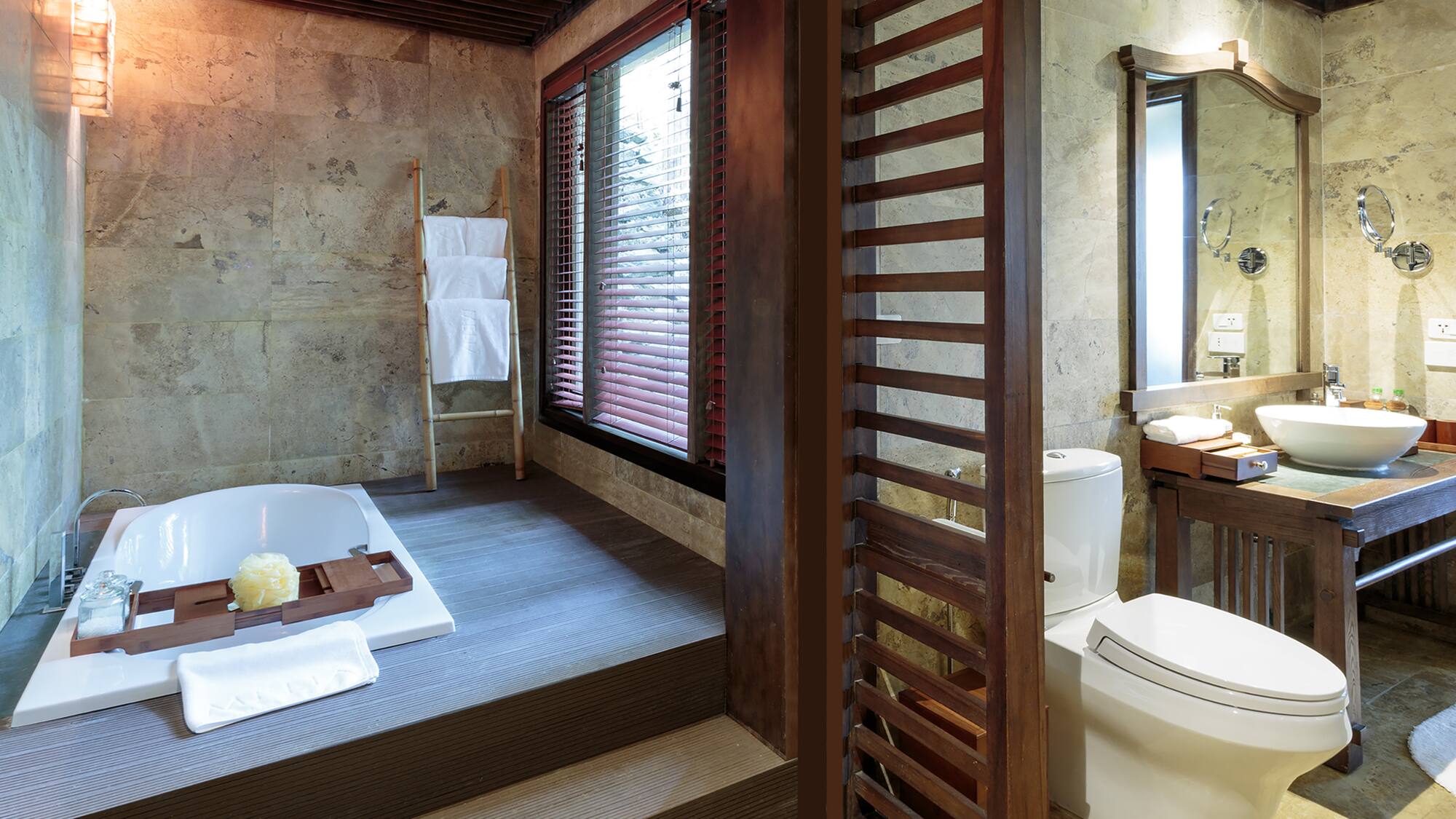 a bathroom with a tub and a toilet