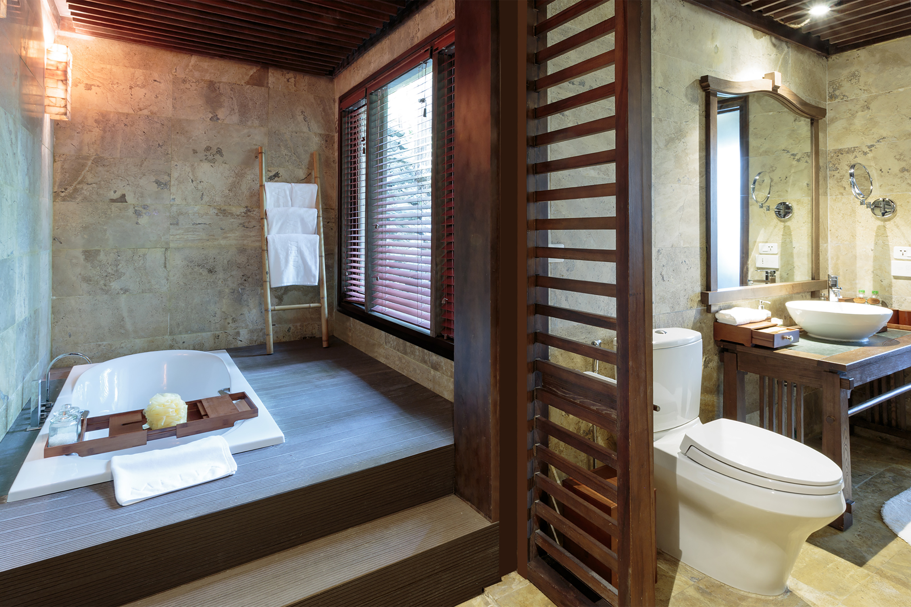 a bathroom with a tub and a toilet