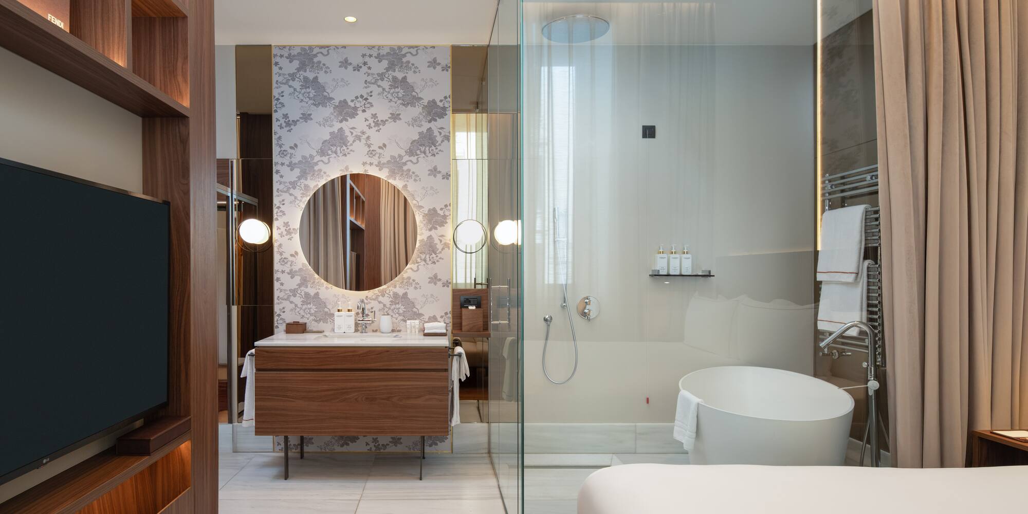 a bathroom with a glass shower and a tub