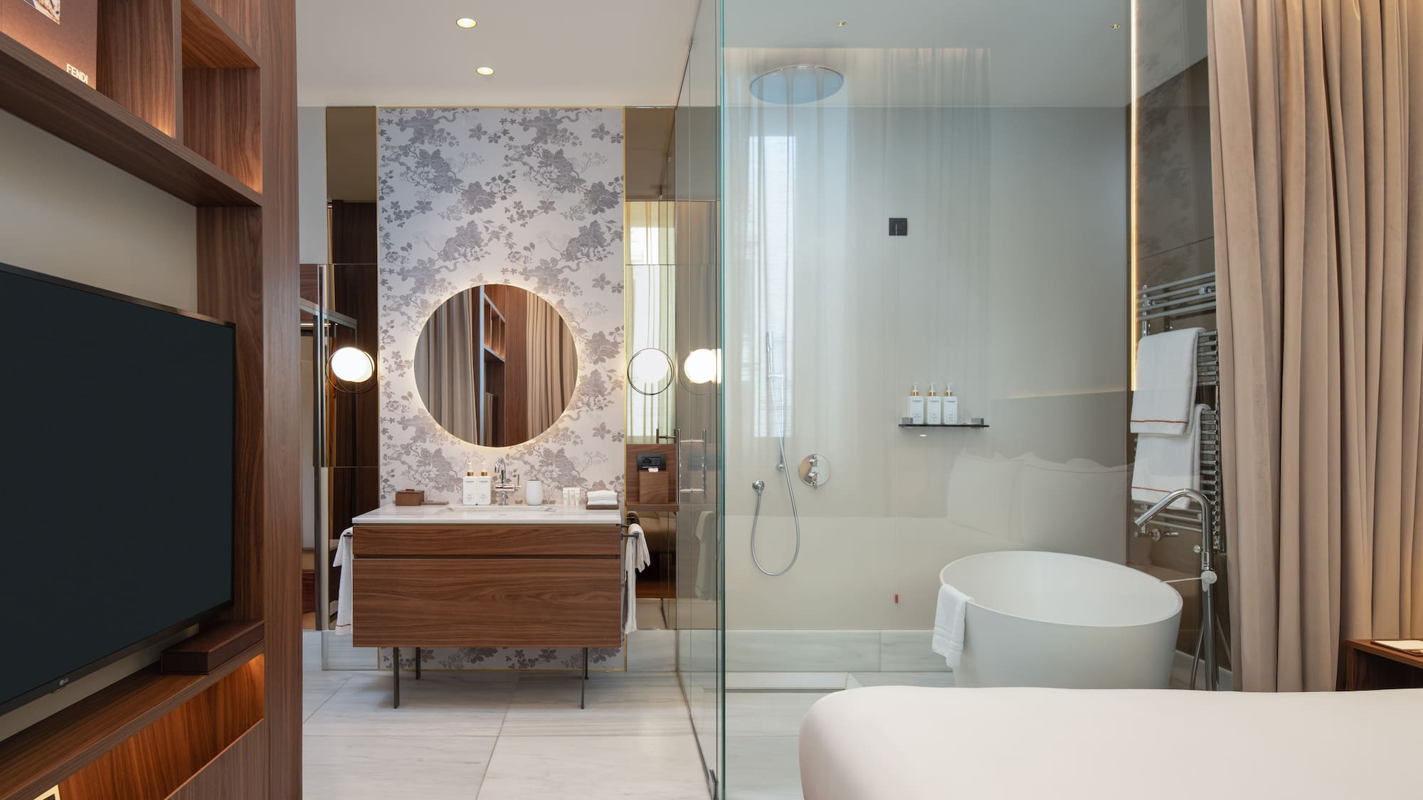 a bathroom with a glass shower and a tub