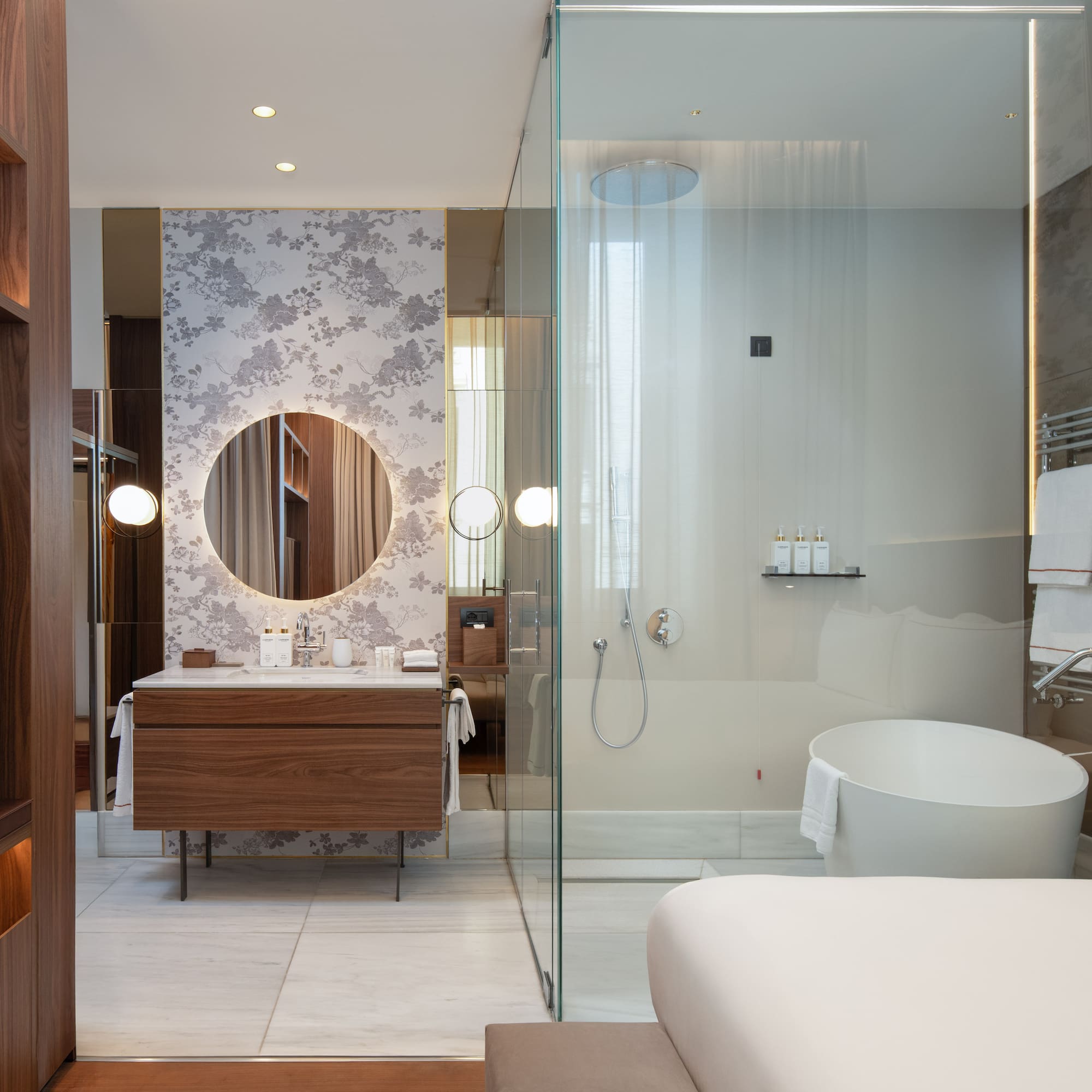 a bathroom with a glass shower and a tub