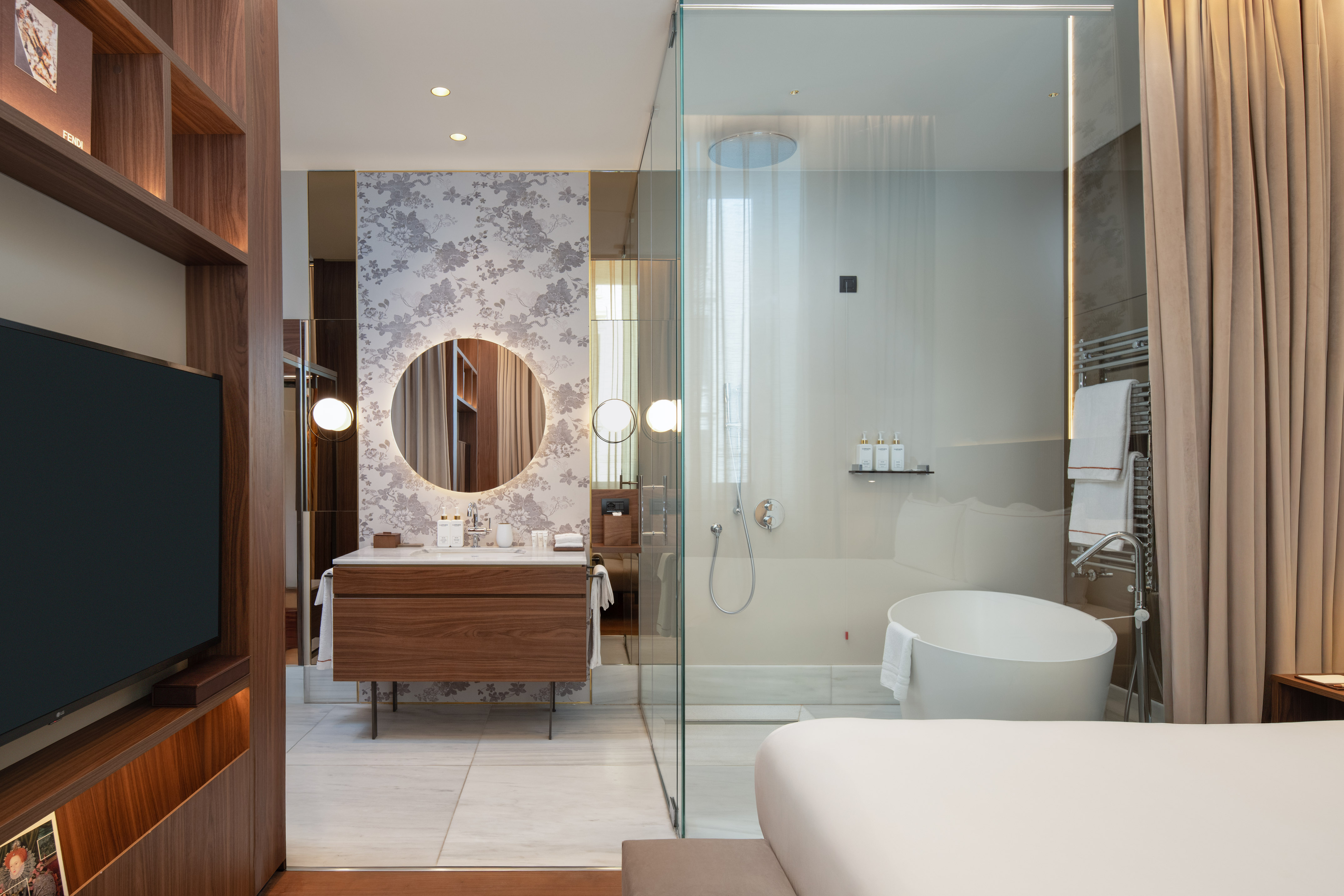 Modern hotel suite, open bathroom with freestanding tub, glass shower, vanity.