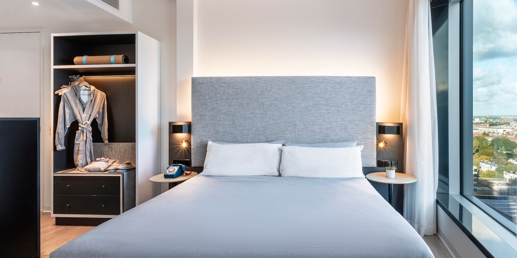 a bed with a large headboard and a closet