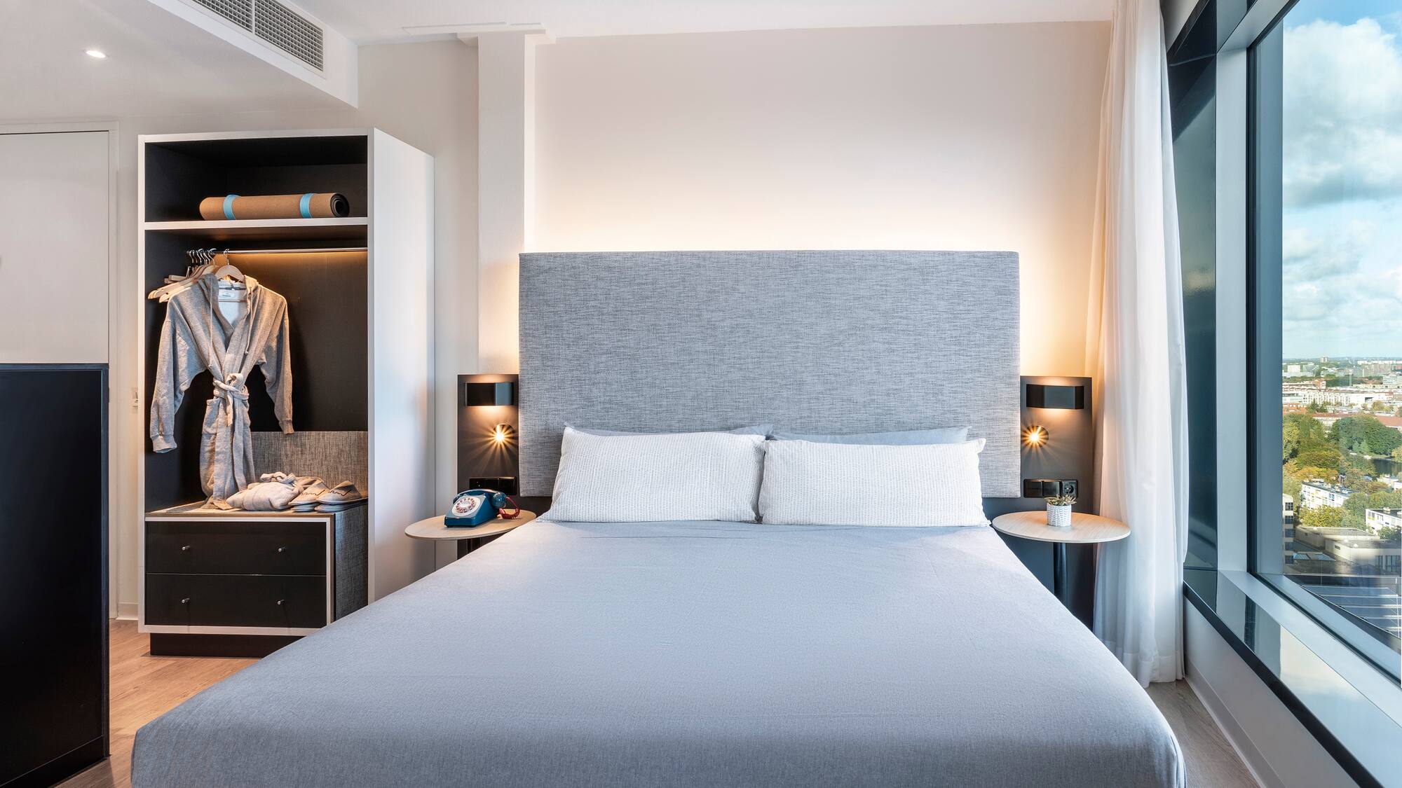 a bed with a large headboard and a closet