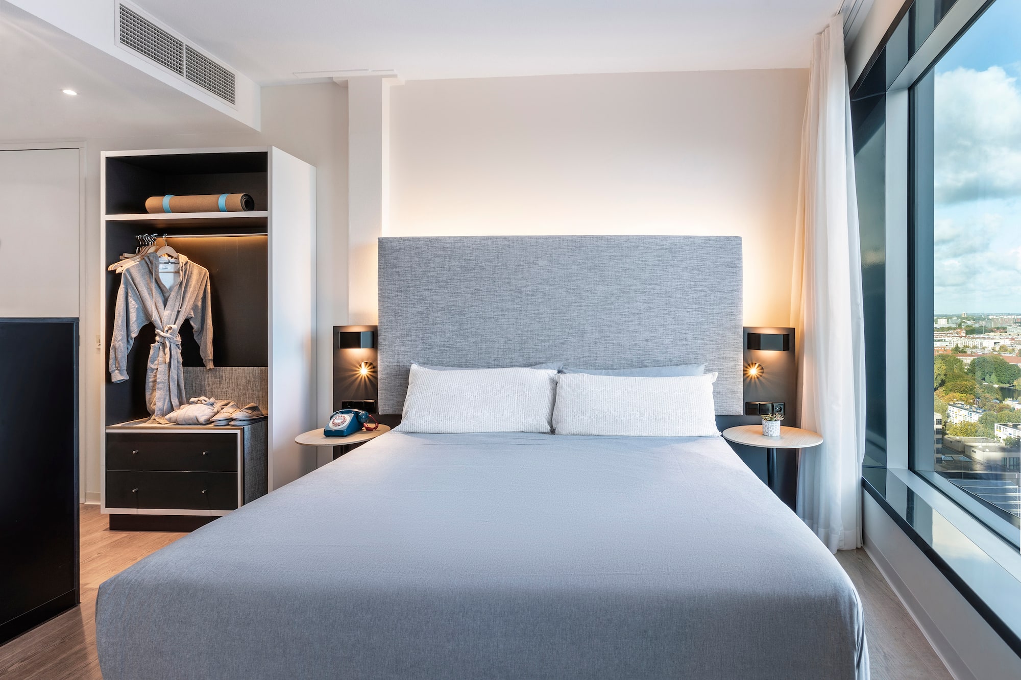 a bed with a large headboard and a closet