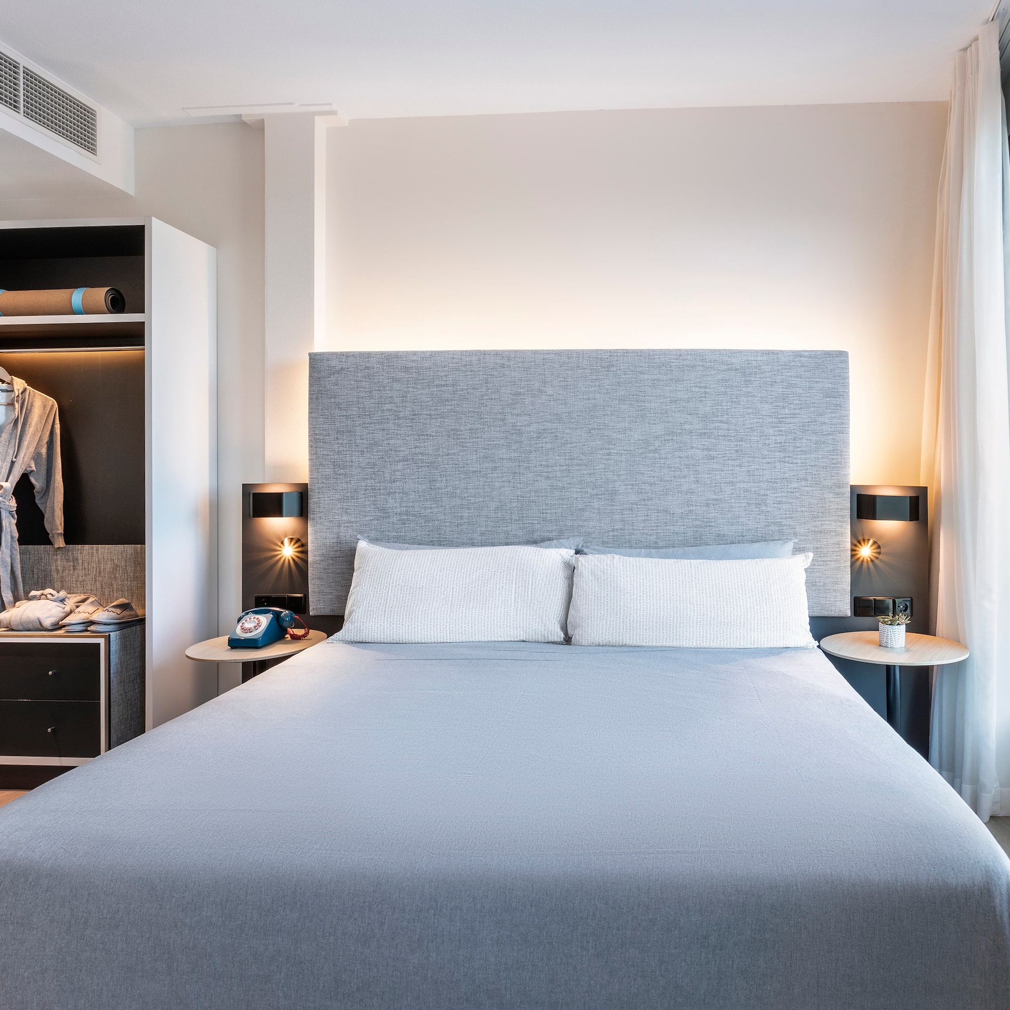 a bed with a large headboard and a closet