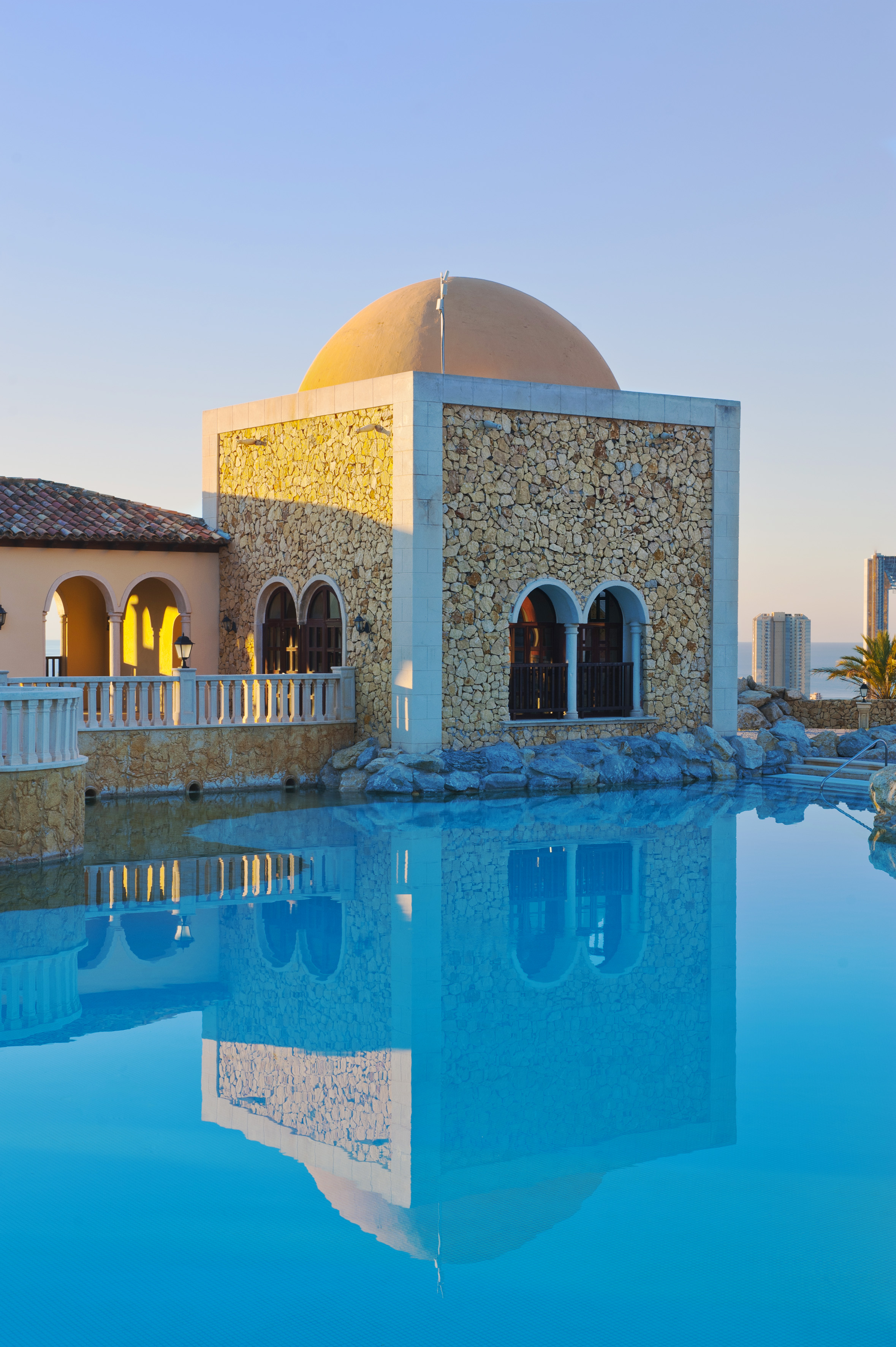 a building with a pool in the background