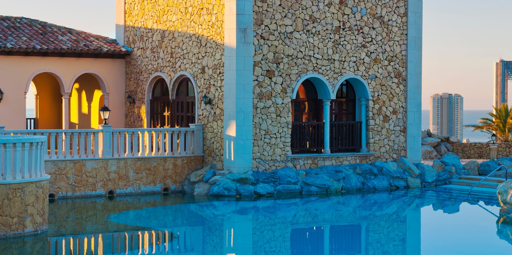 a building with a pool in the background