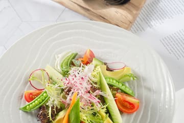 a plate of salad with avocado and vegetables