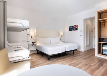 a room with two beds and a bunk bed