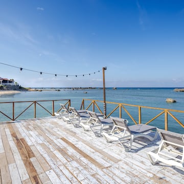 chairs on a deck overlooking the water