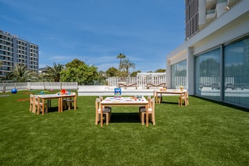 a table and chairs on a lawn