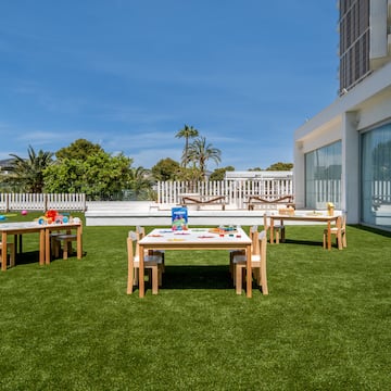 a table and chairs on a lawn