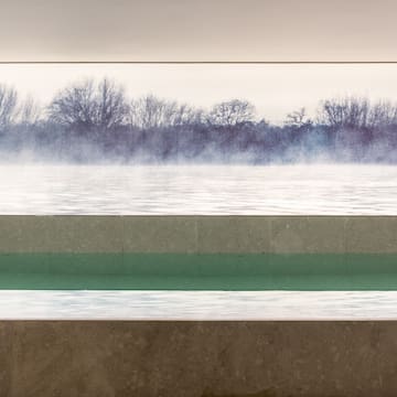 a pool with a view of a lake and trees