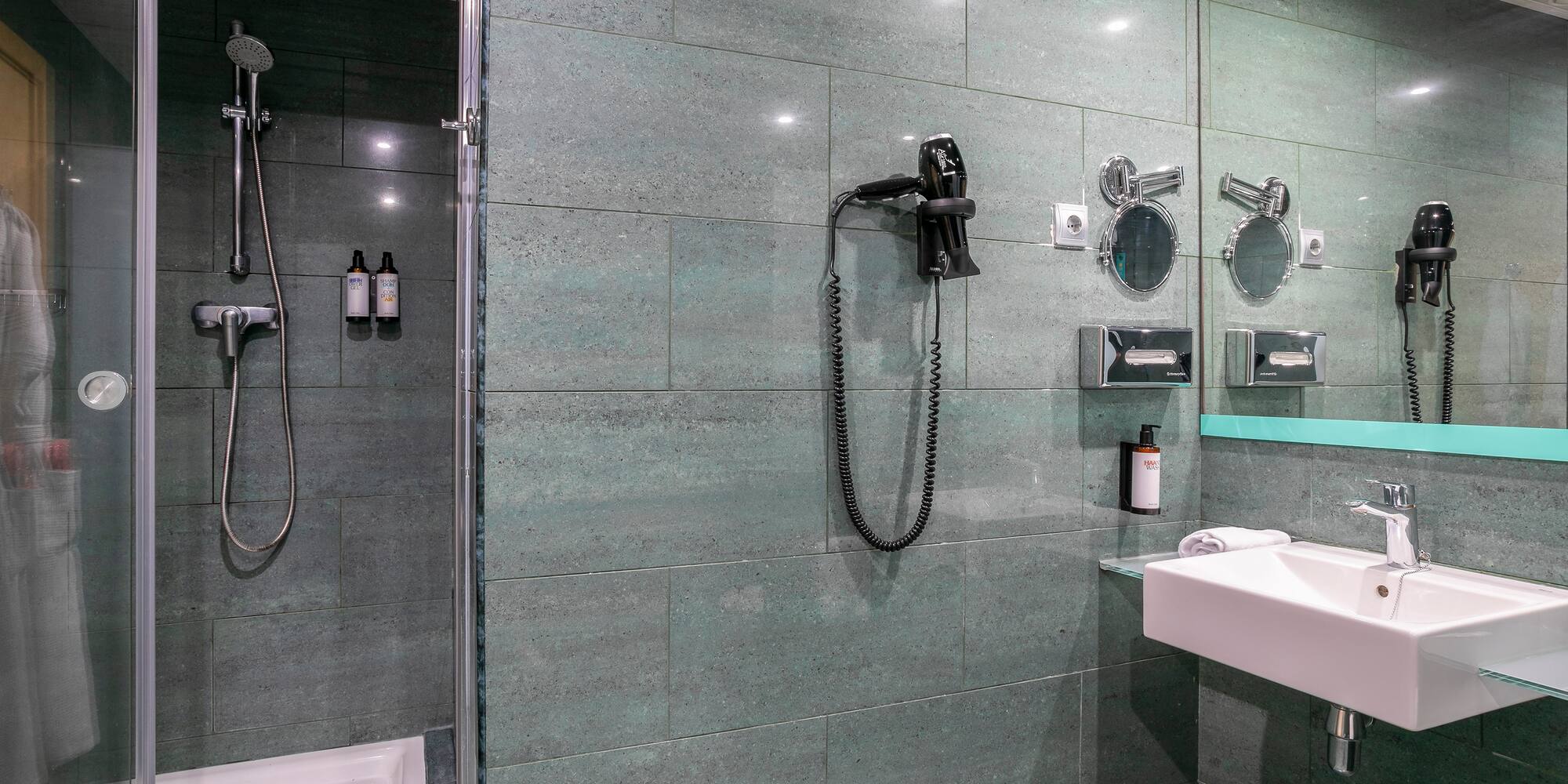 a bathroom with a shower and a sink