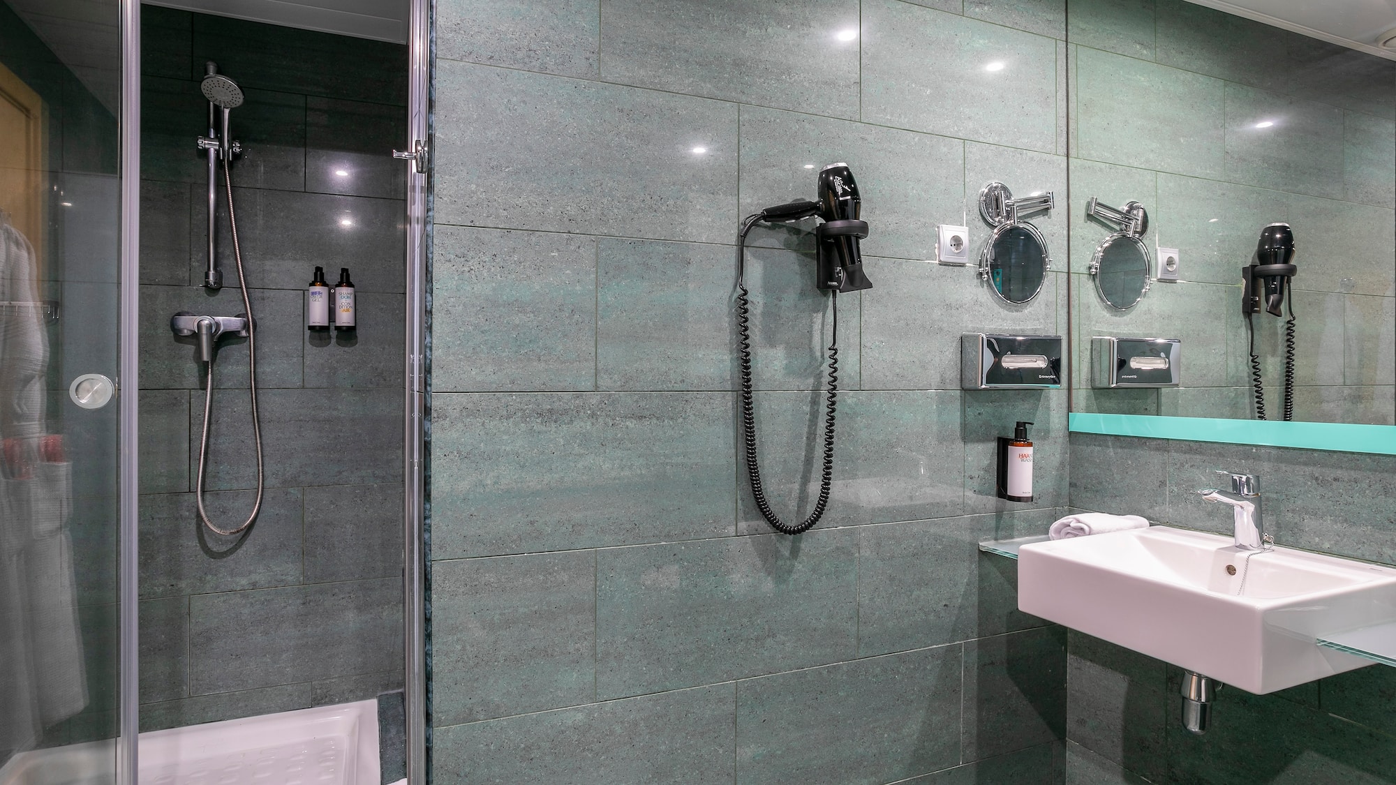 a bathroom with a shower and a sink