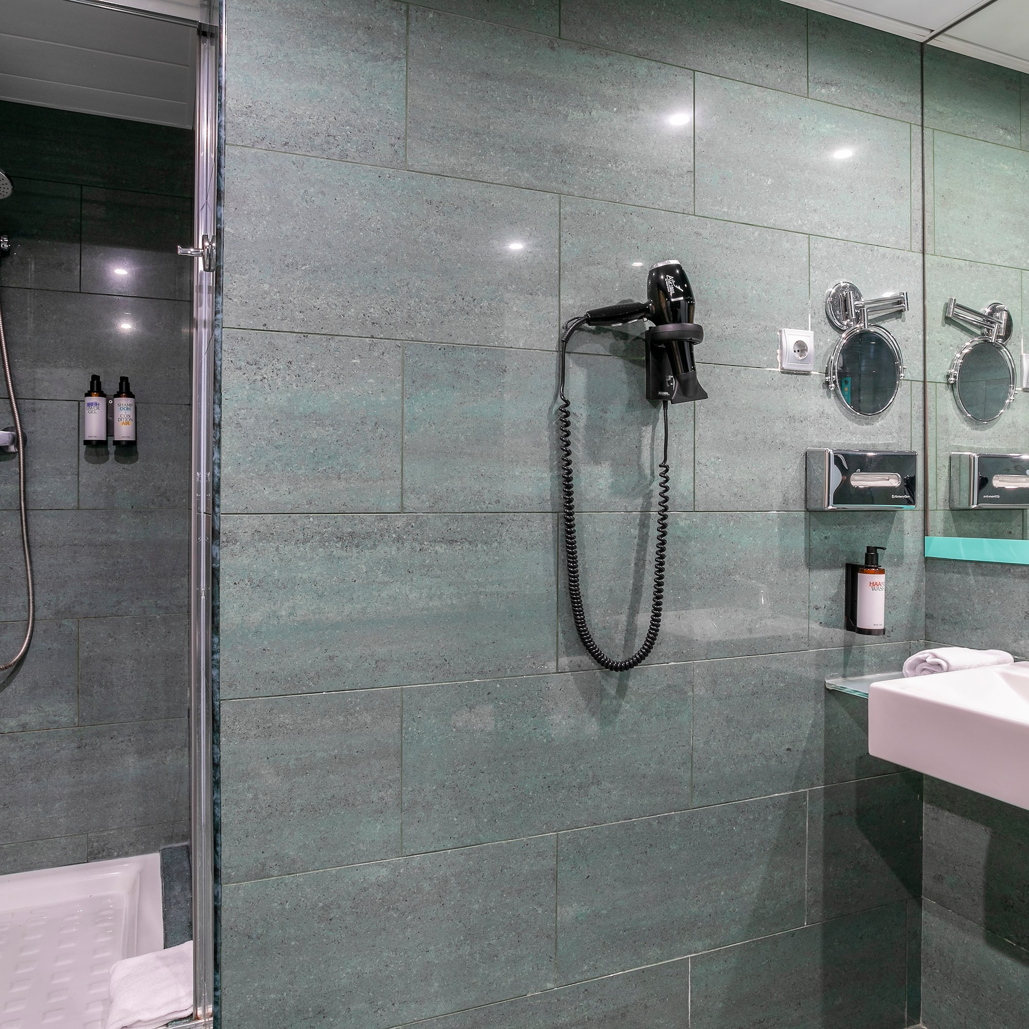 a bathroom with a shower and a sink