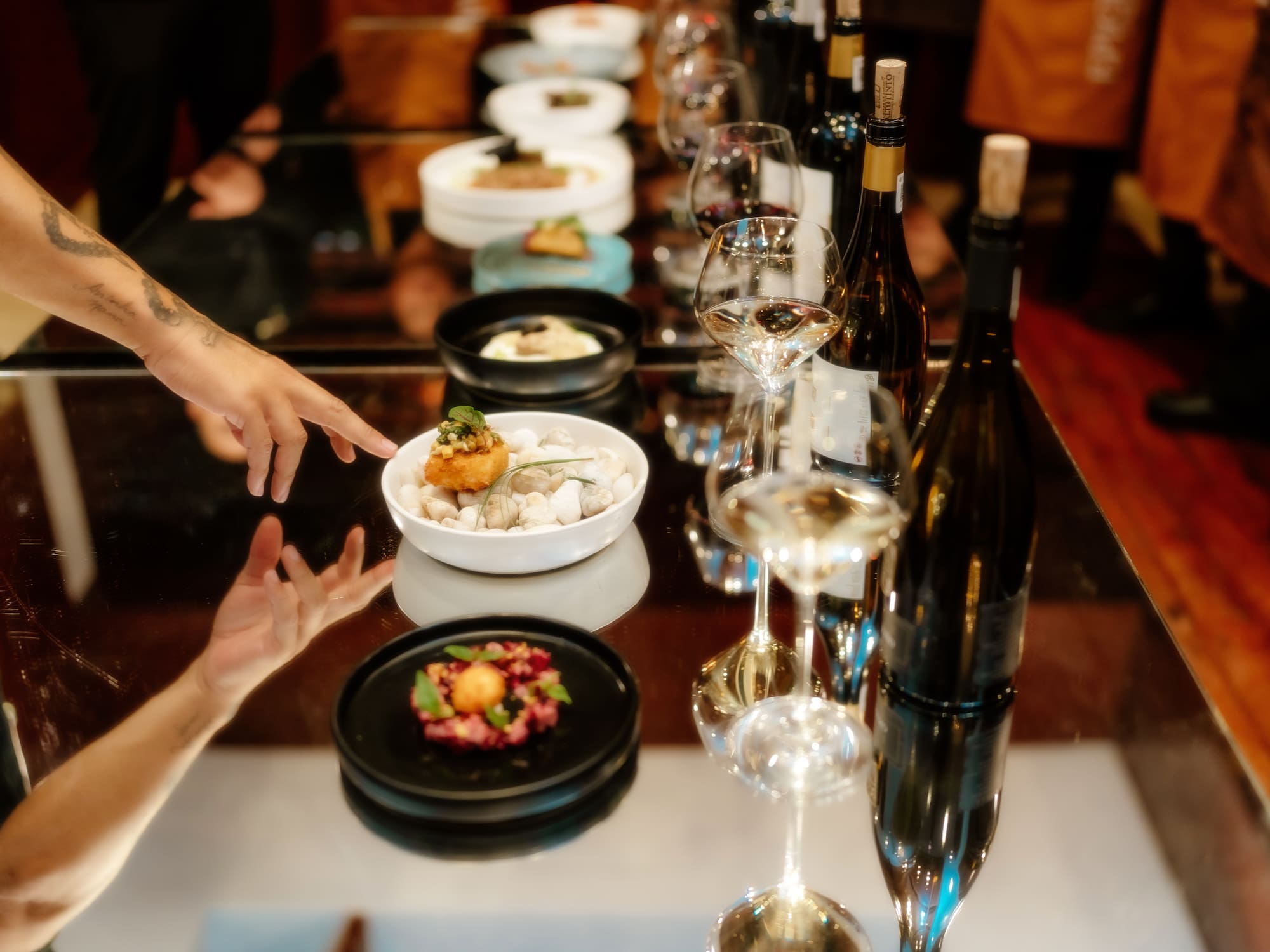 a table with food and wine glasses