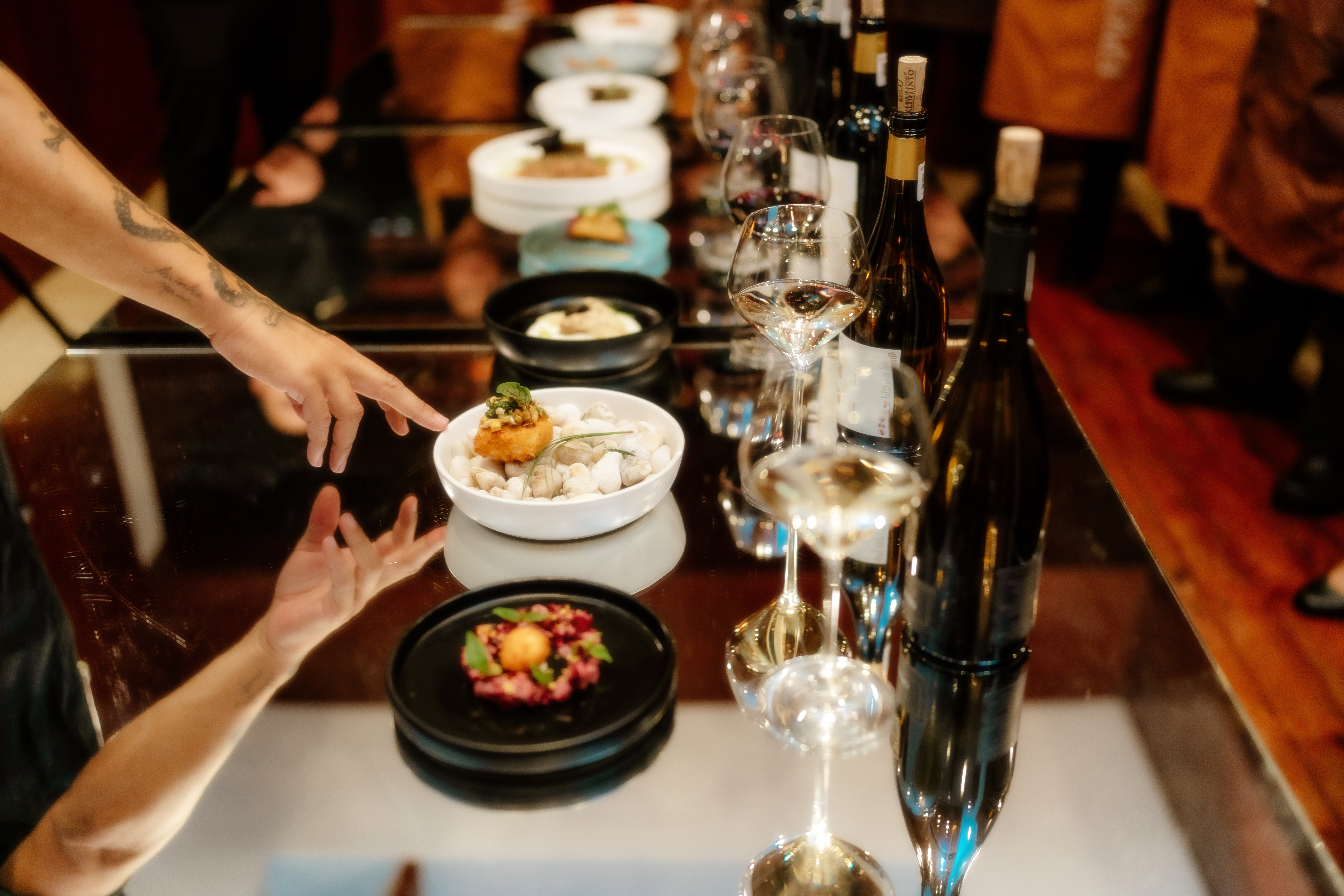a table with food and wine glasses