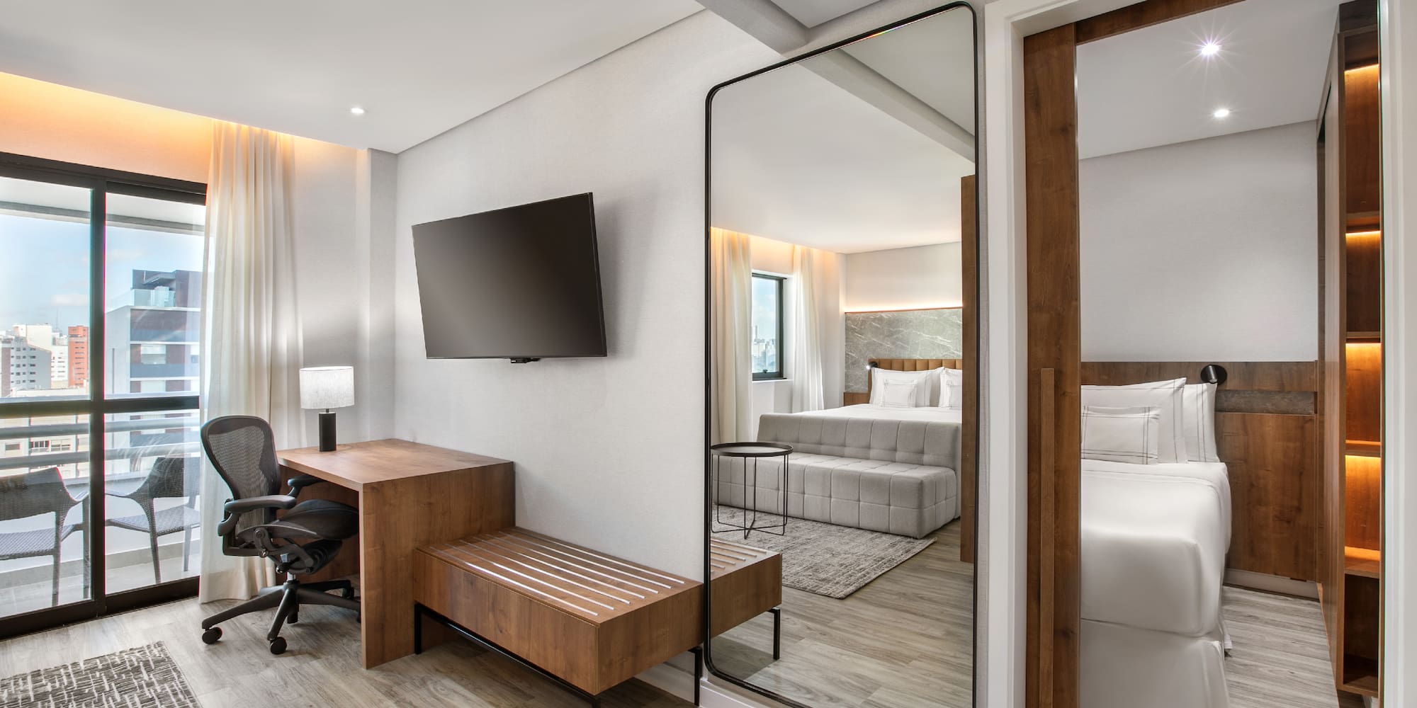 a room with a mirror and a bed