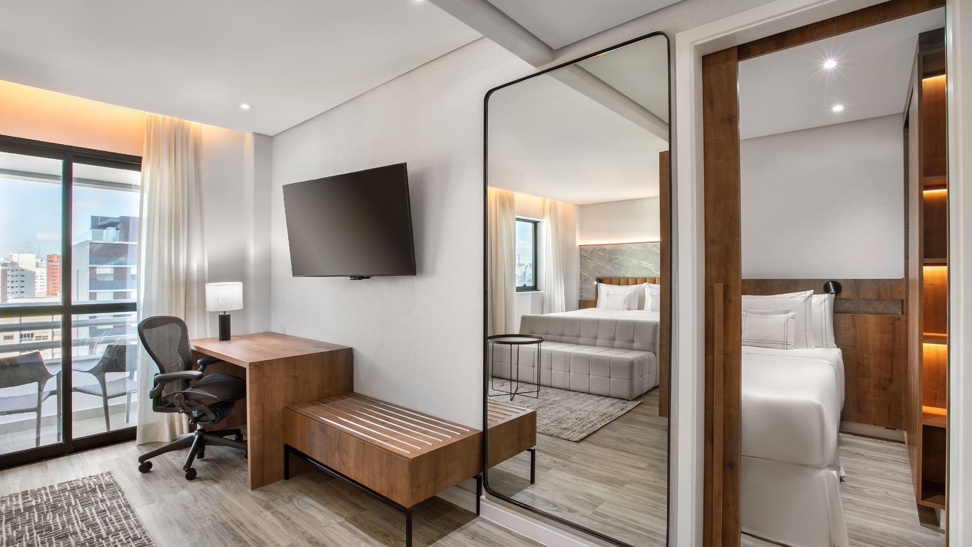 a room with a mirror and a bed