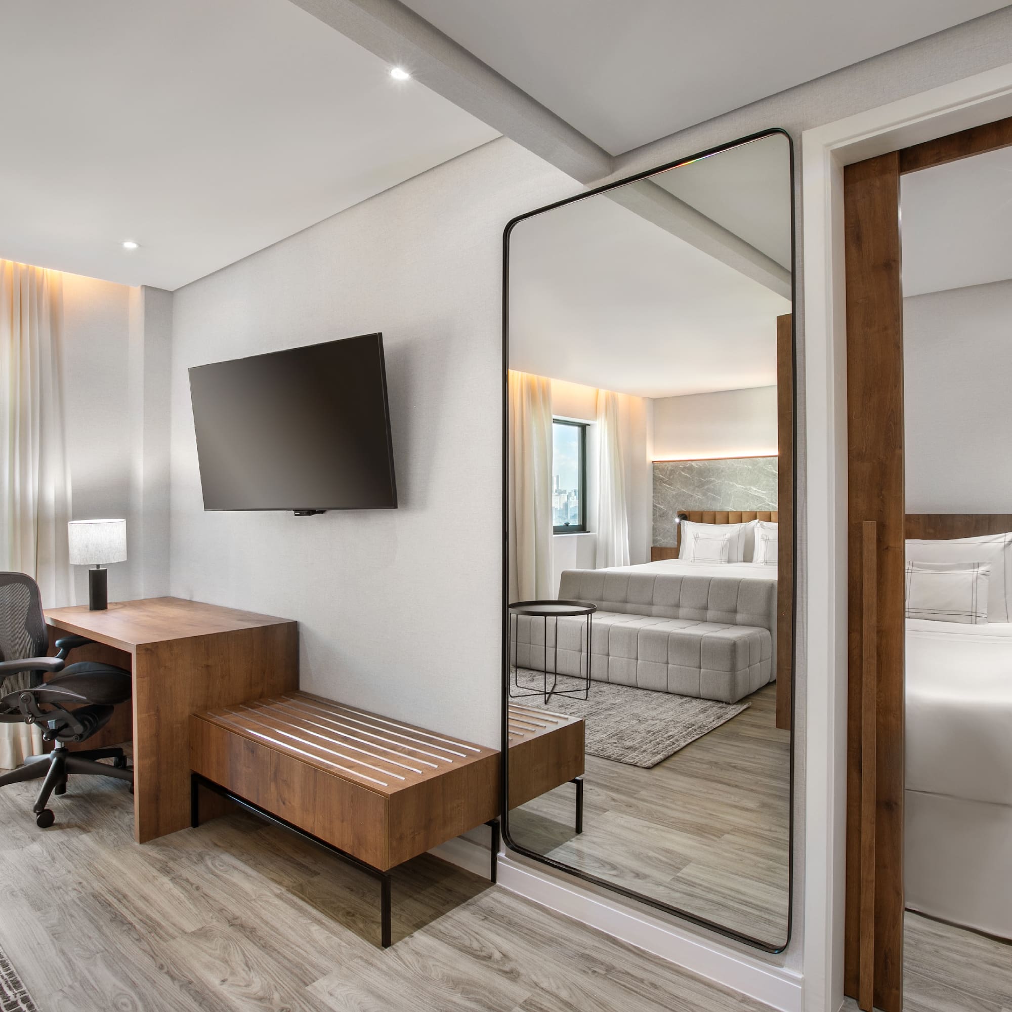 a room with a mirror and a bed