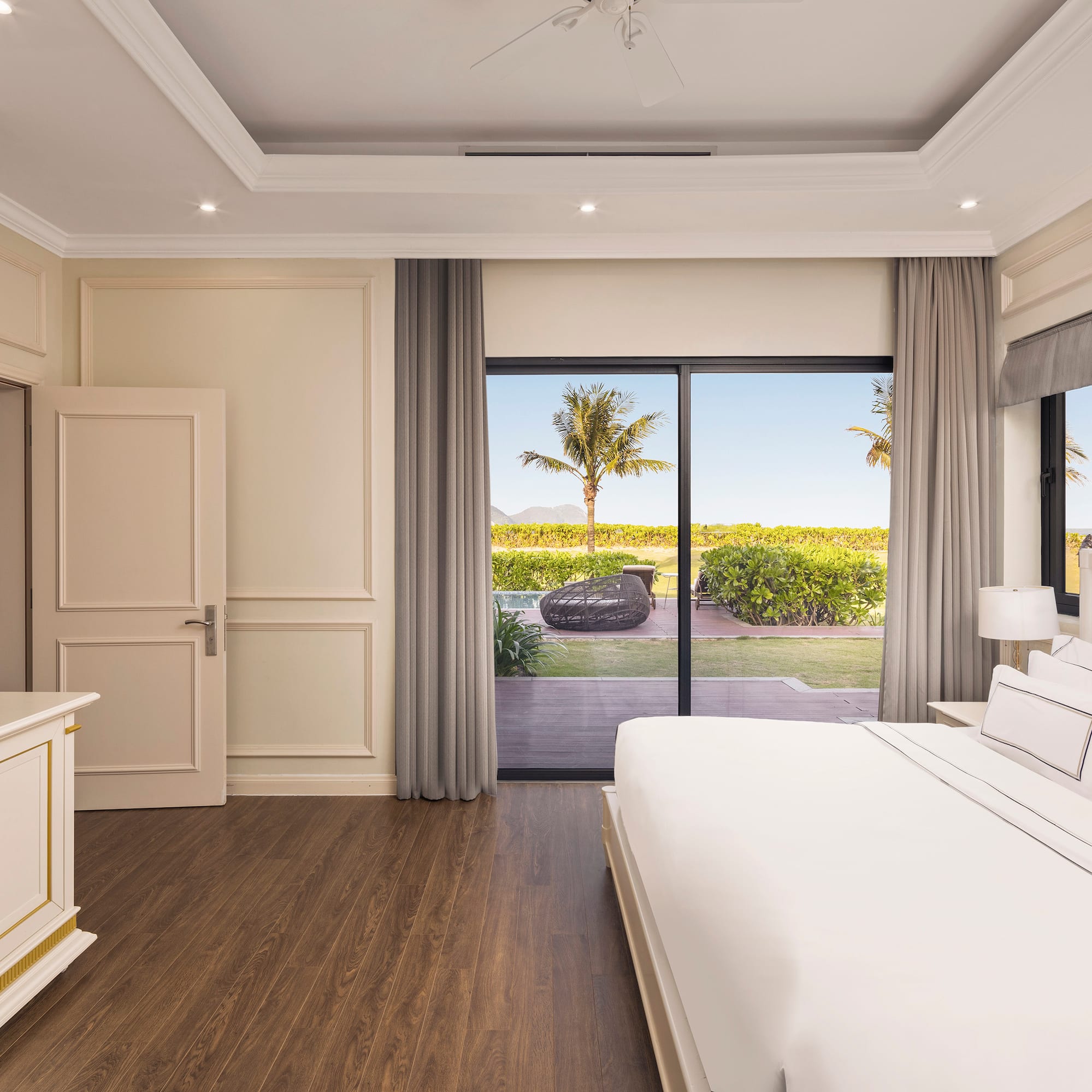 a bedroom with a large bed and a glass door