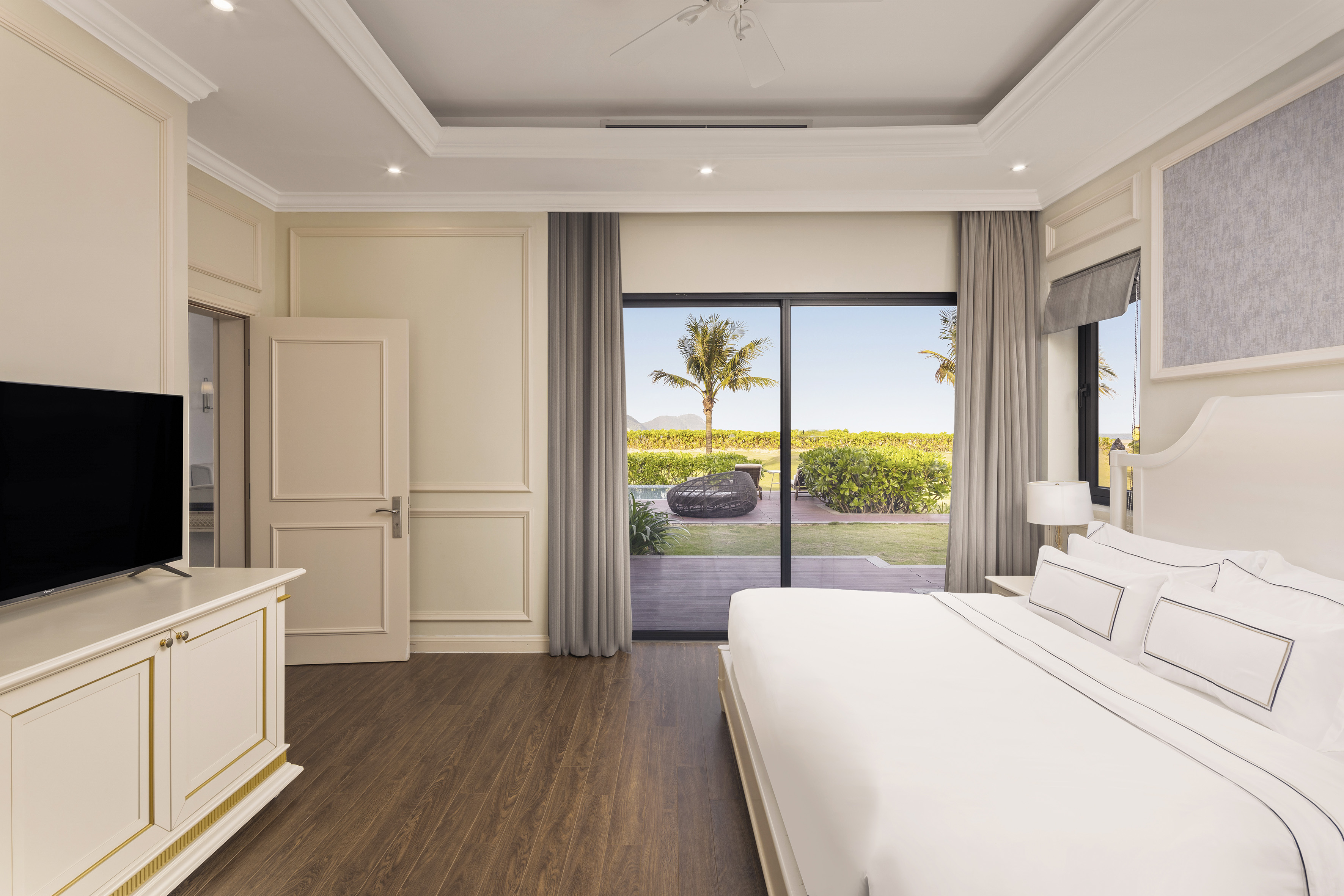 a bedroom with a large bed and a glass door