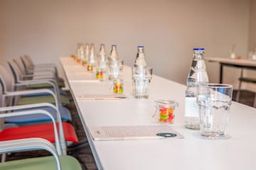 a row of water bottles and candy on a table