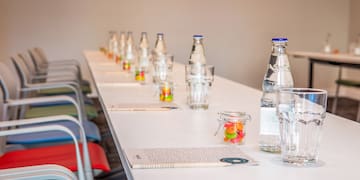 a row of water bottles and candy on a table