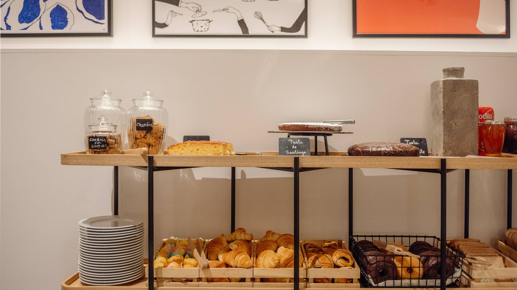 a shelf with pastries and plates on it