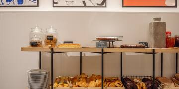 a shelf with pastries and plates on it