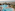 a swimming pool with palm trees and a beach