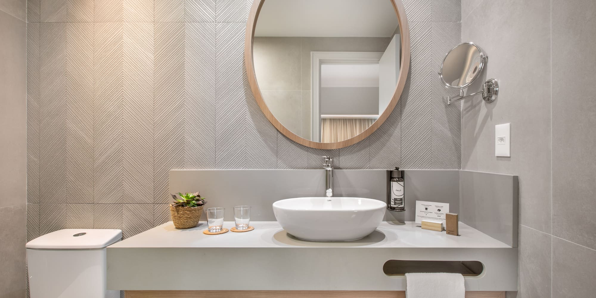 a bathroom with a round mirror