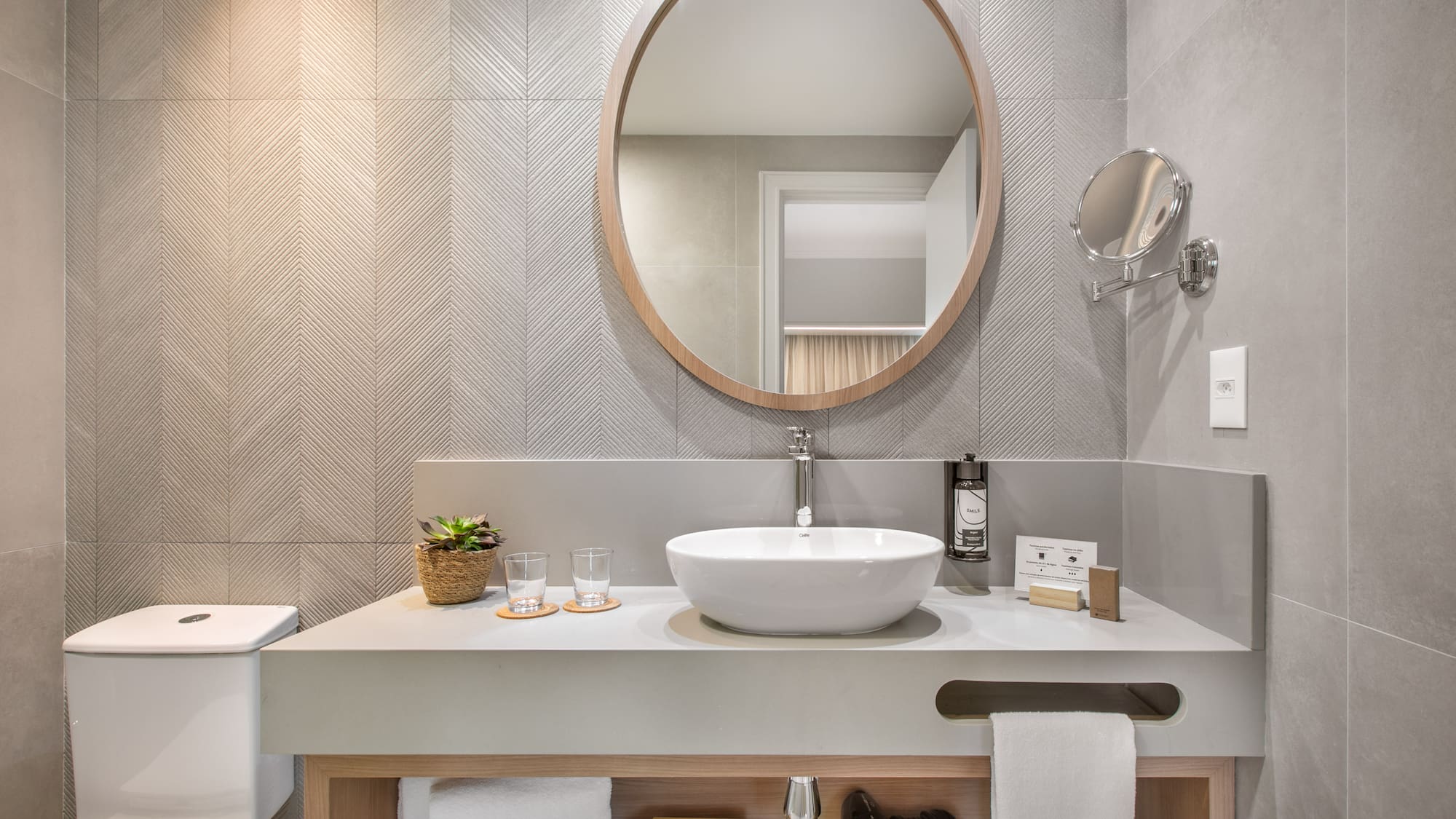 a bathroom with a round mirror