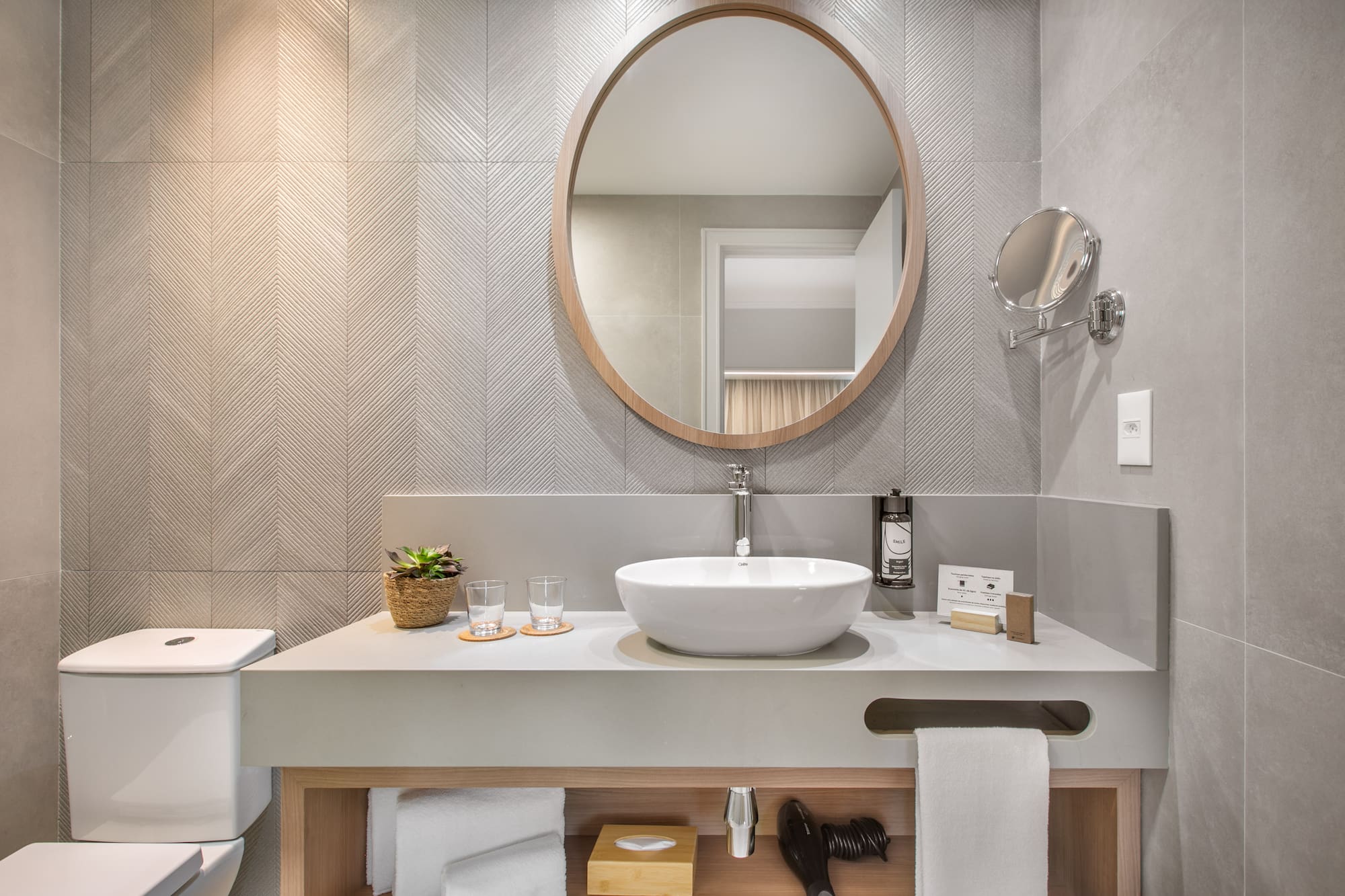 a bathroom with a round mirror