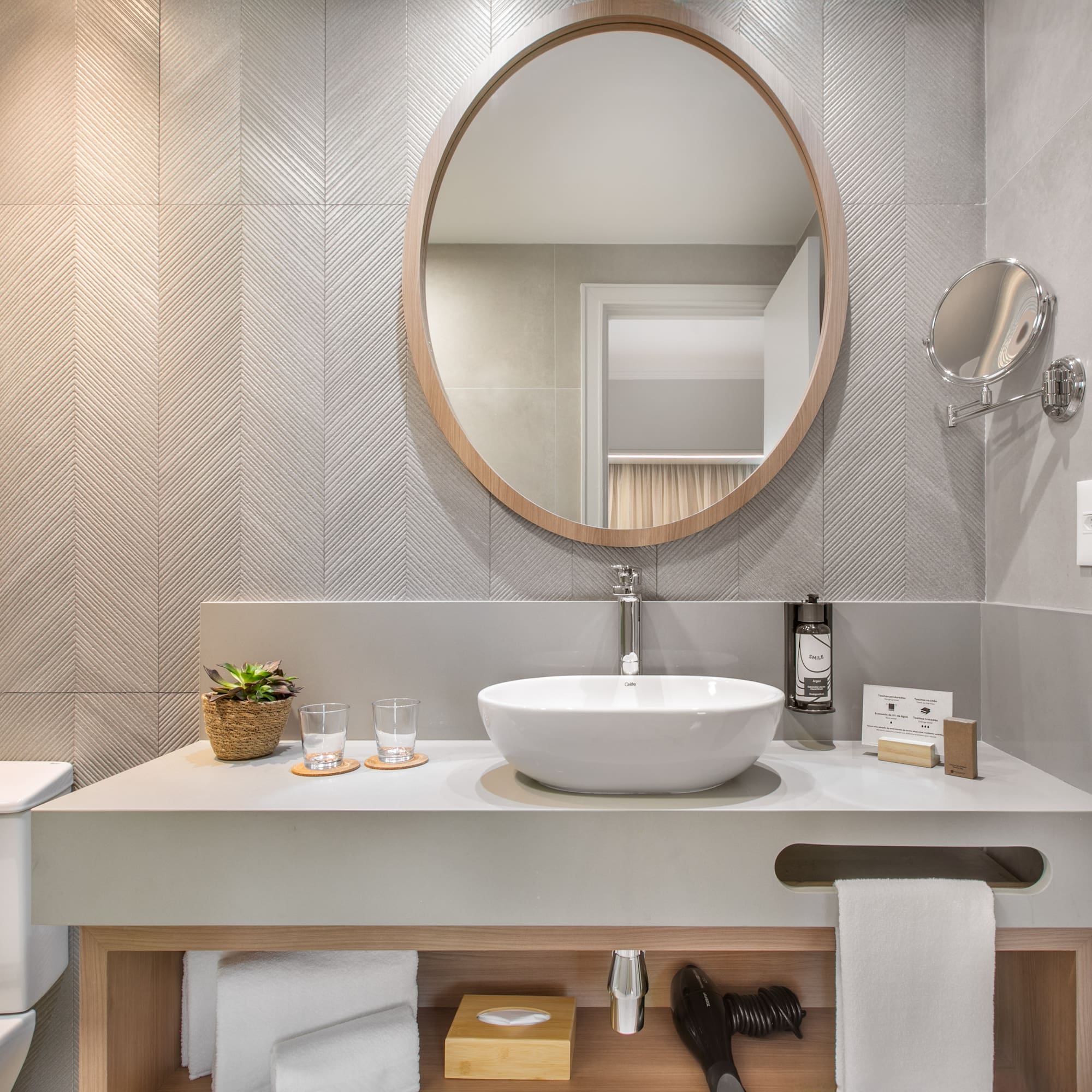 a bathroom with a round mirror