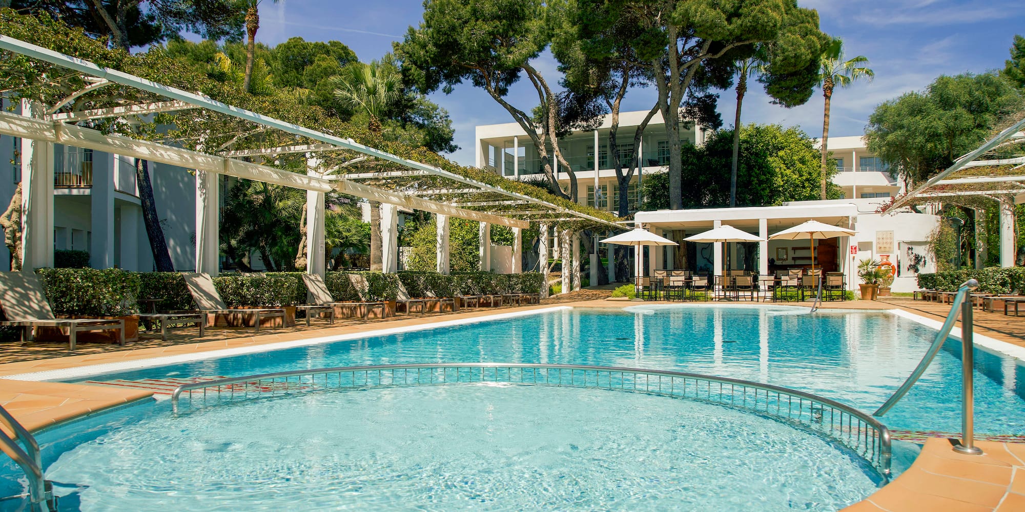 a pool with chairs and a white roof