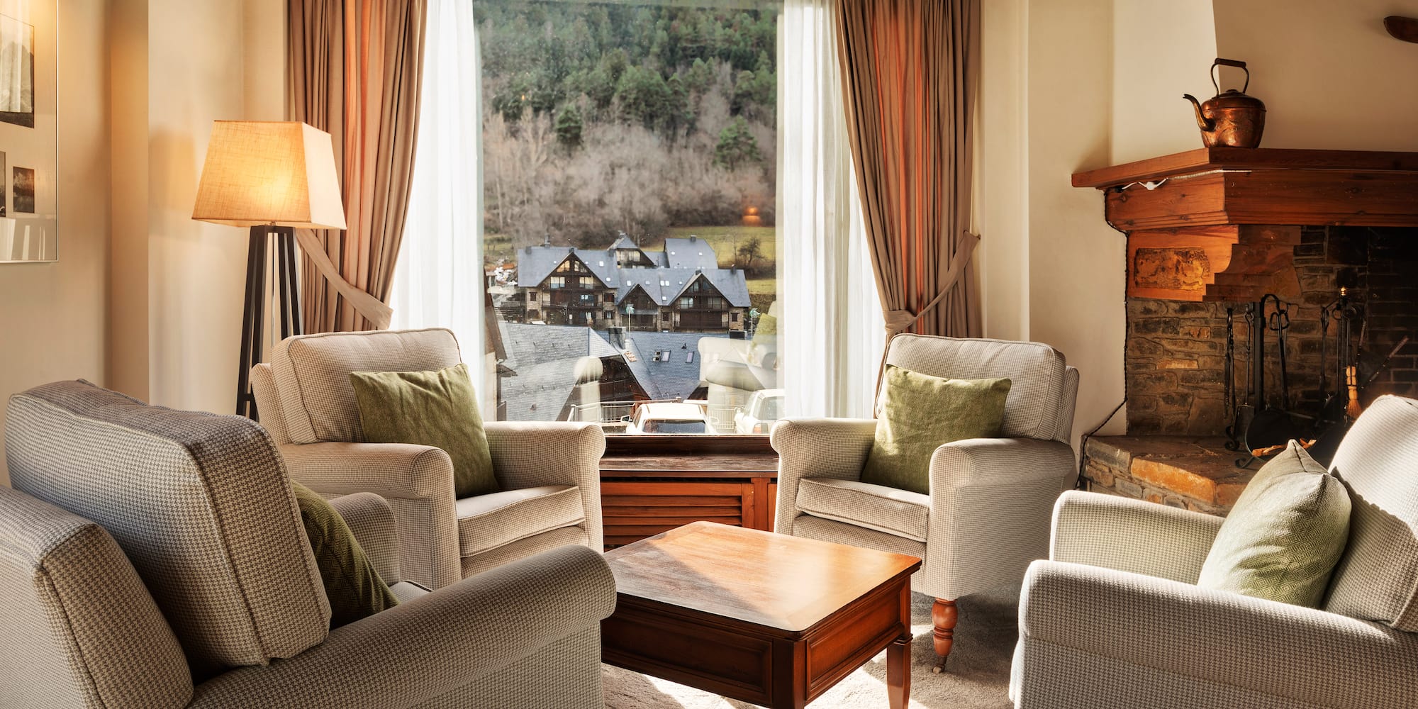 a living room with a fireplace and chairs