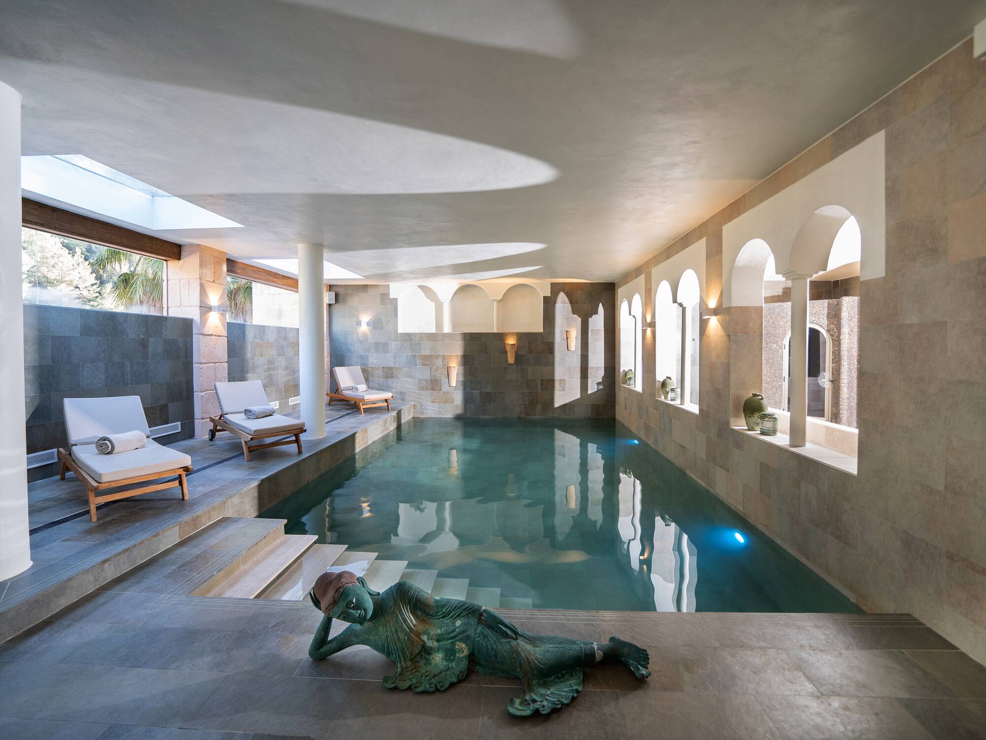 a swimming pool with a statue of a mermaid