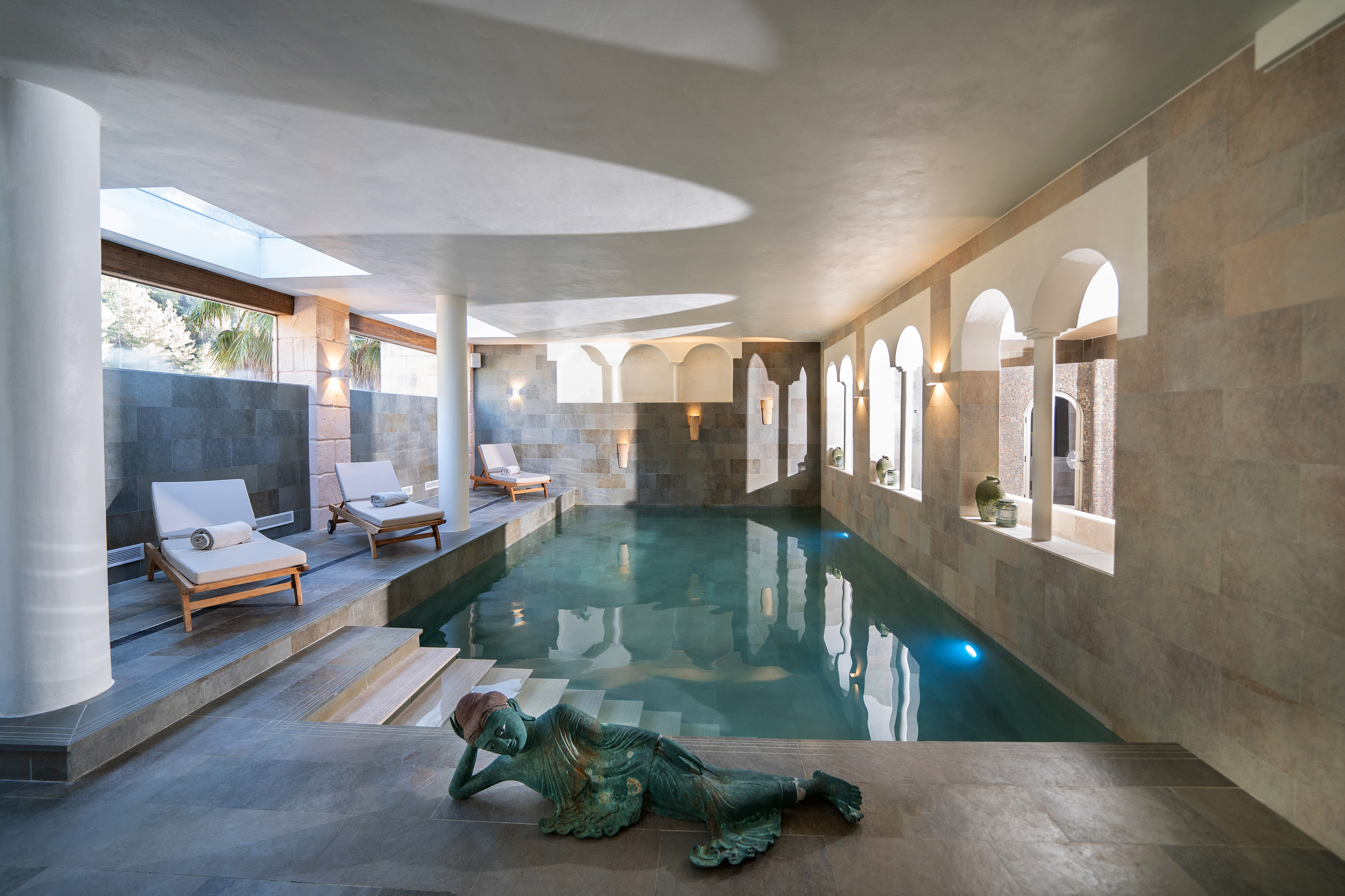 a swimming pool with a statue of a mermaid