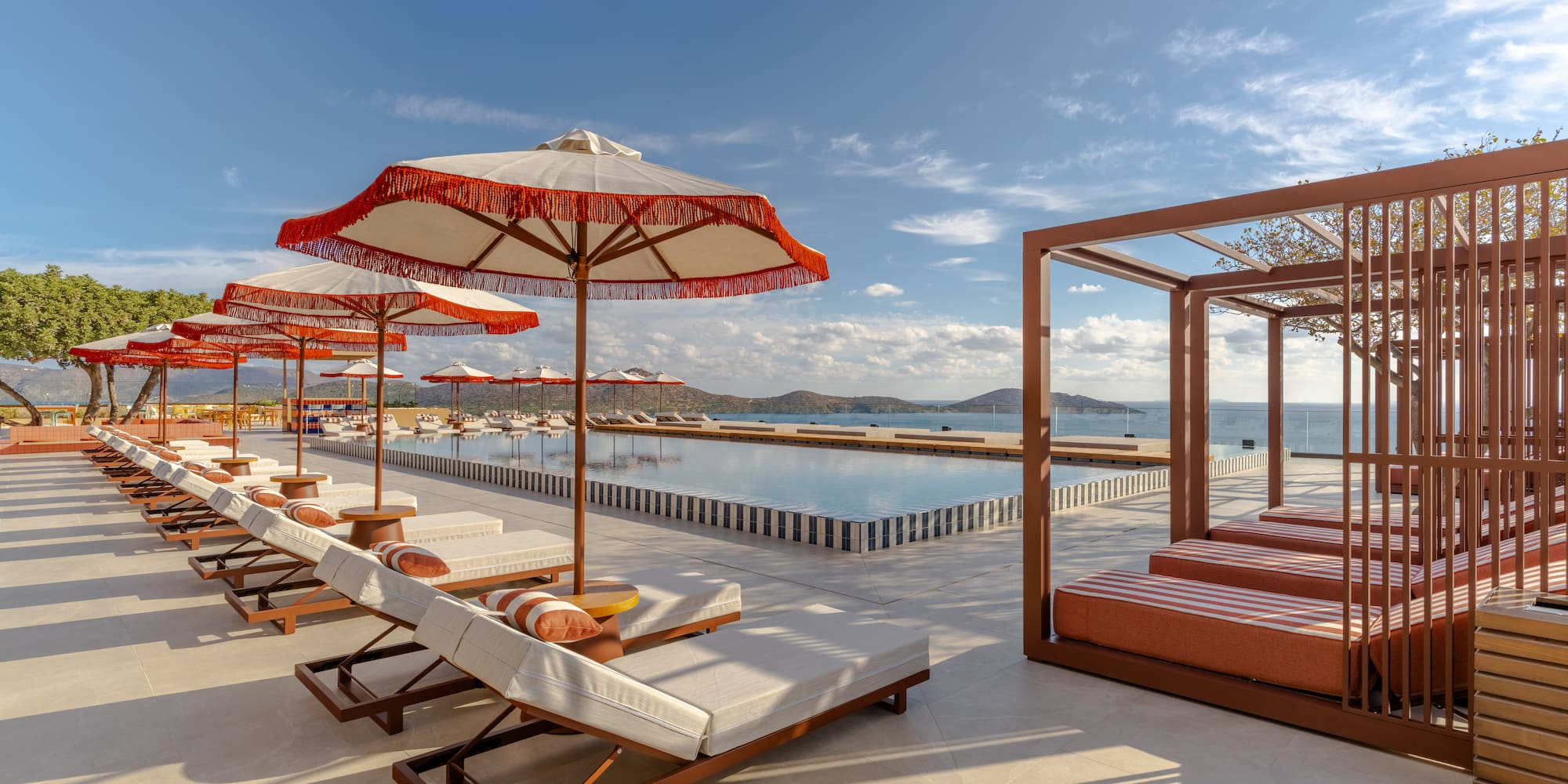 a pool with lounge chairs and umbrellas