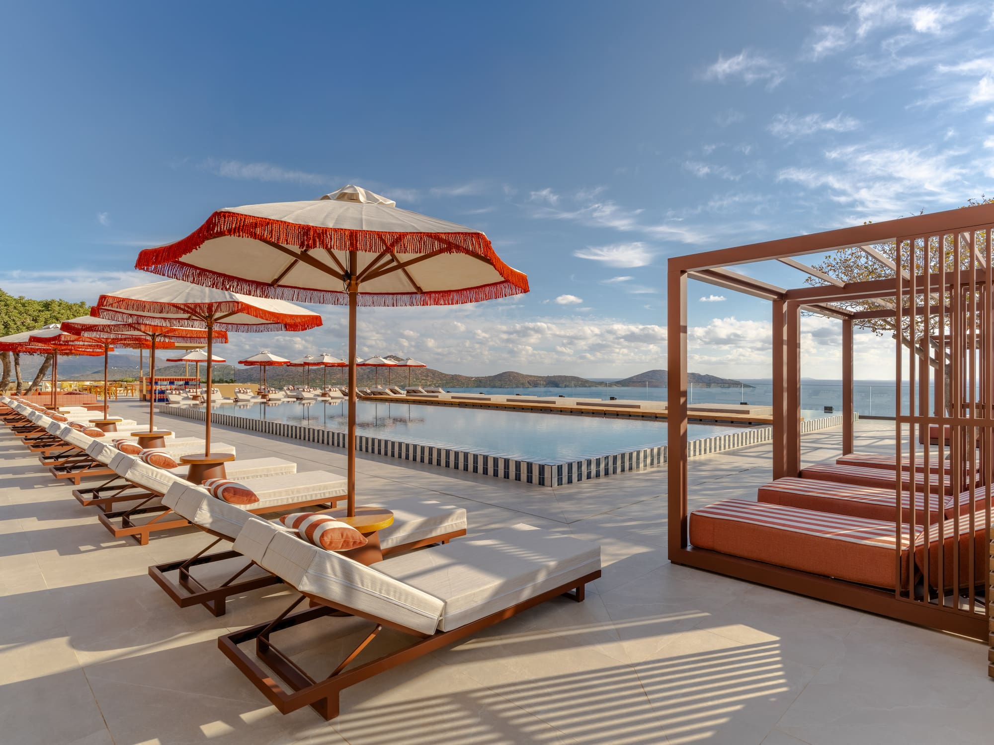 a pool with lounge chairs and umbrellas