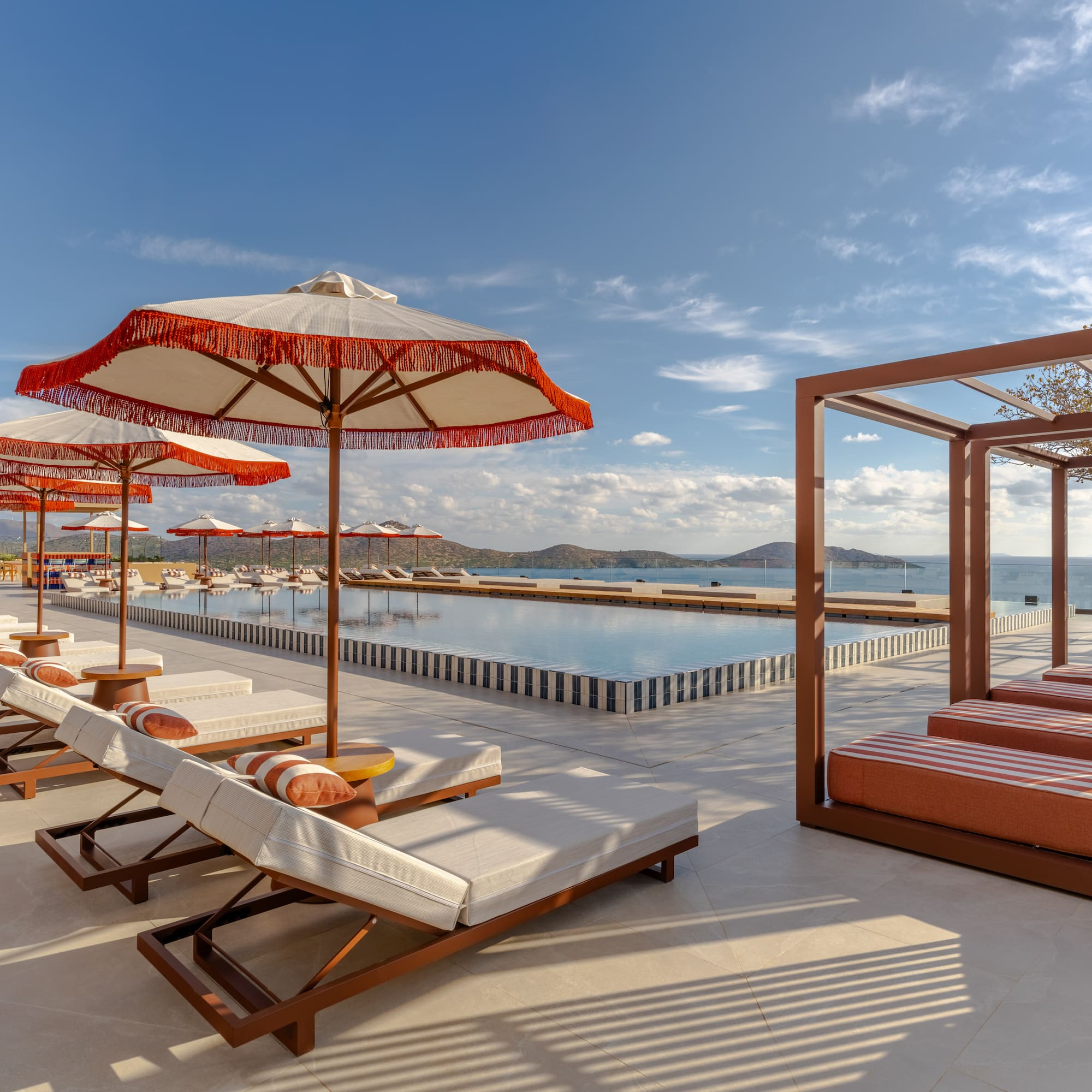 a pool with lounge chairs and umbrellas