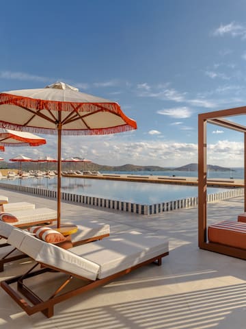 a pool with lounge chairs and umbrellas