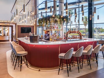 a bar with chairs and a bar stools