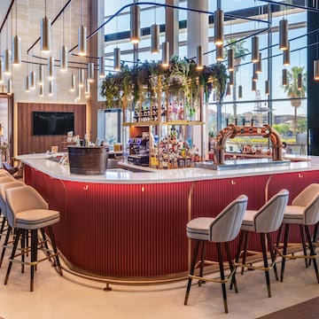 a bar with chairs and a bar stools