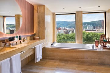 a bathroom with a large tub and a large window