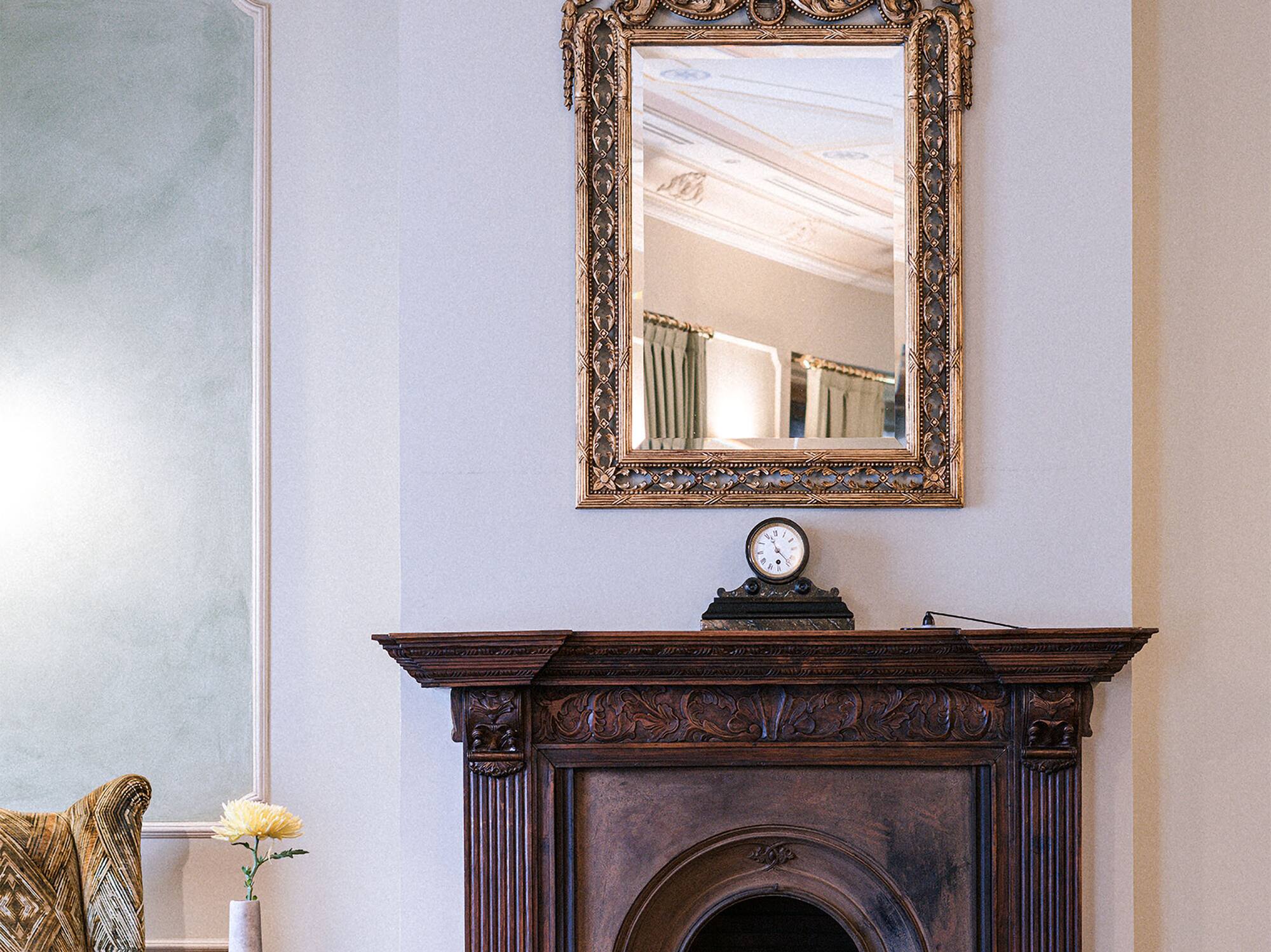 a mirror above a fireplace