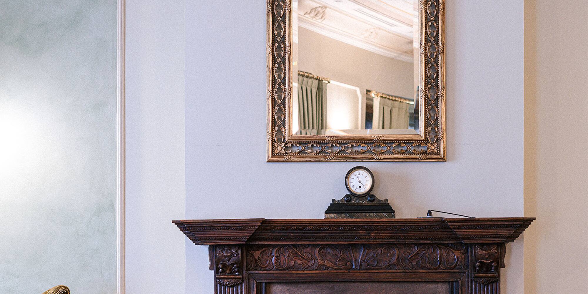a mirror above a fireplace